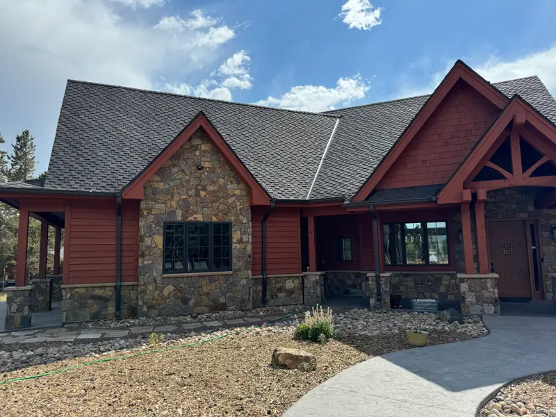 Front elevation of a rust-red painted mountain home